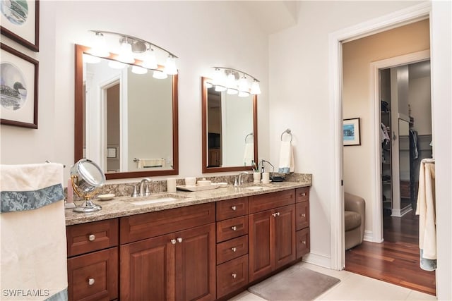 bathroom with tile patterned flooring, double vanity, and a sink