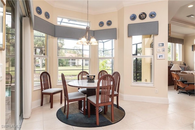 dining space featuring baseboards, an inviting chandelier, light tile patterned flooring, and crown molding