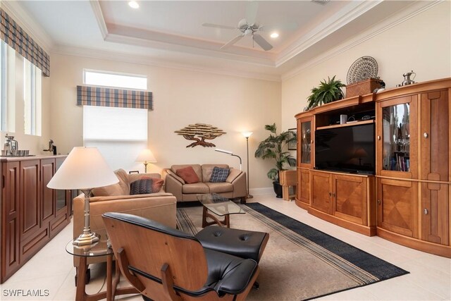 living room with crown molding, a raised ceiling, and ceiling fan