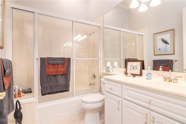 full bath featuring tile patterned floors, enclosed tub / shower combo, toilet, and vanity