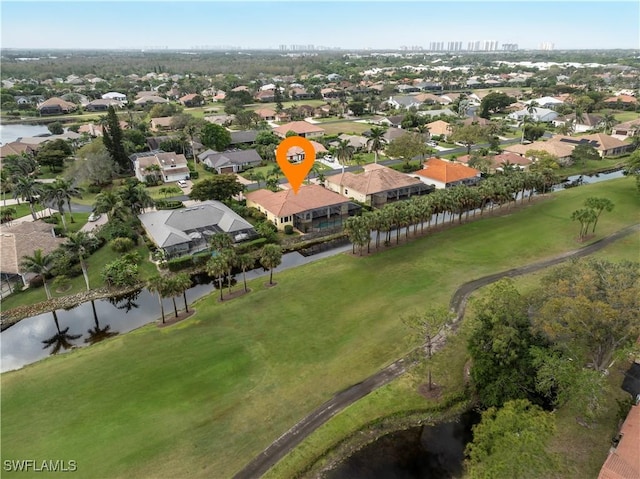 drone / aerial view featuring a residential view and a water view