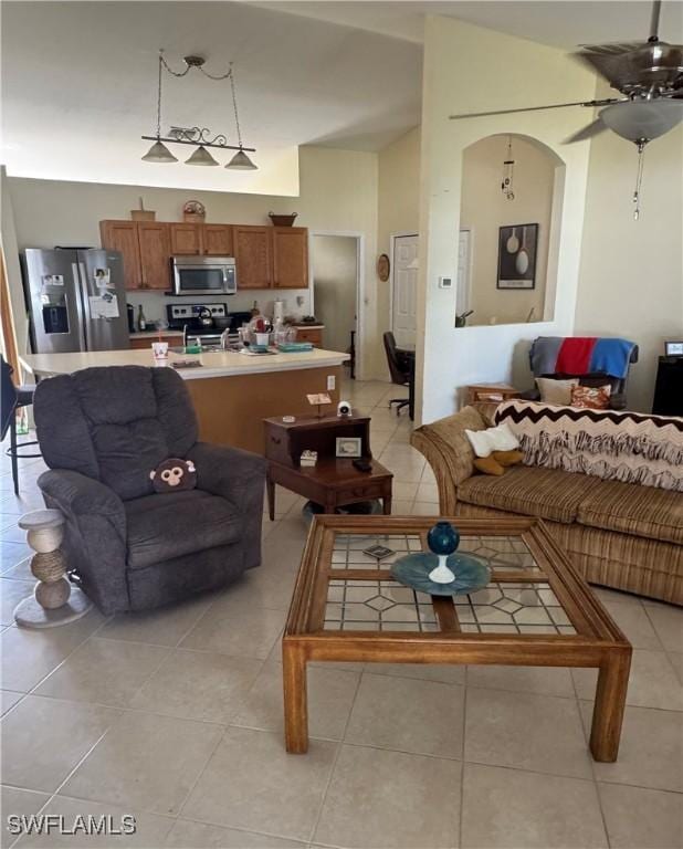 living room with lofted ceiling and light tile patterned flooring