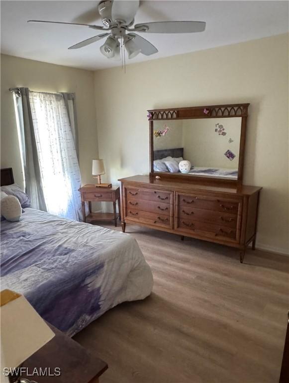 bedroom featuring wood finished floors and ceiling fan