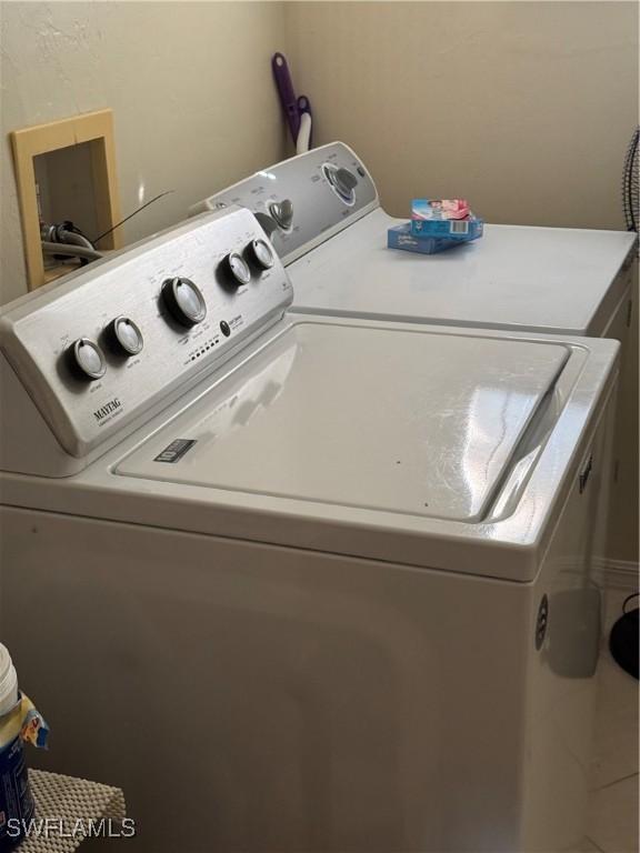 laundry room featuring laundry area and washing machine and clothes dryer