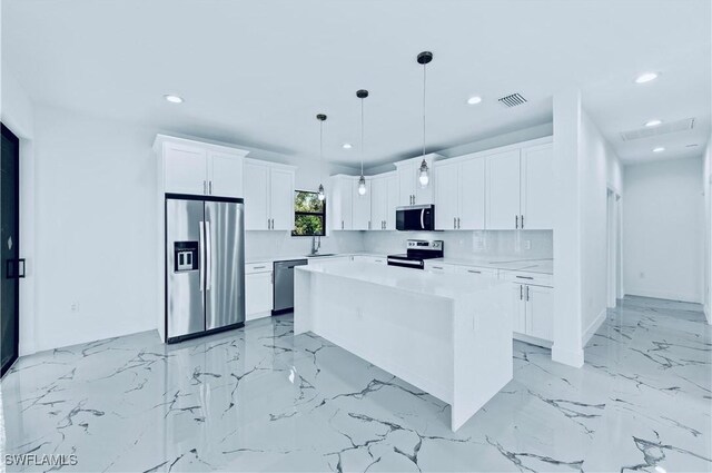 kitchen featuring backsplash, light countertops, appliances with stainless steel finishes, marble finish floor, and white cabinetry