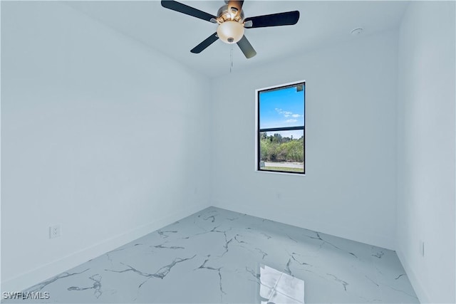 unfurnished room with baseboards, marble finish floor, and ceiling fan