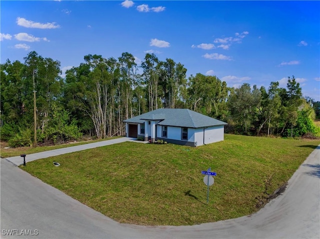 ranch-style home with concrete driveway, a garage, and a front lawn