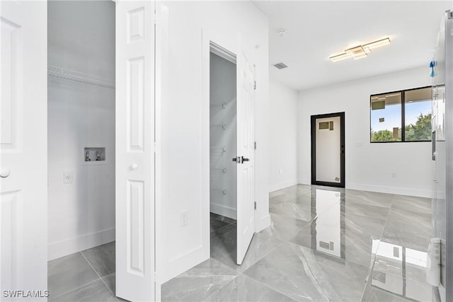 interior space with baseboards, visible vents, and marble finish floor