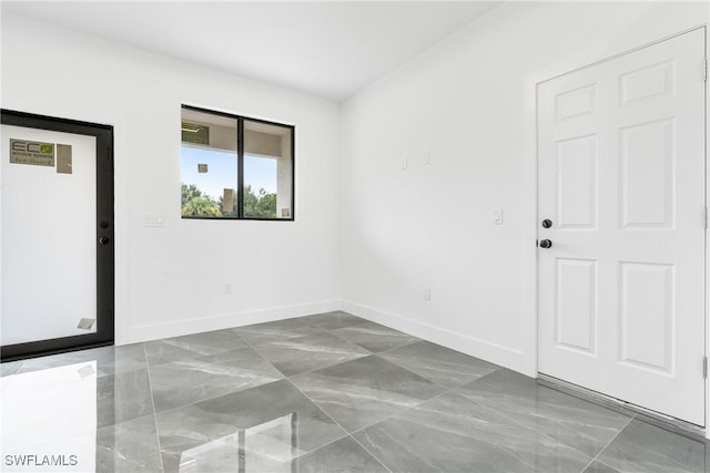 unfurnished room featuring baseboards