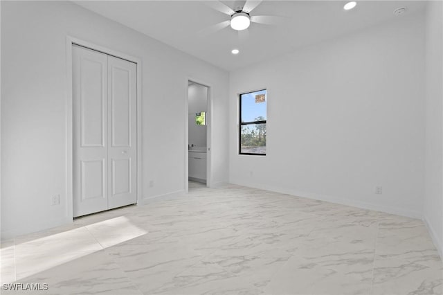 unfurnished bedroom with recessed lighting, a closet, baseboards, and marble finish floor