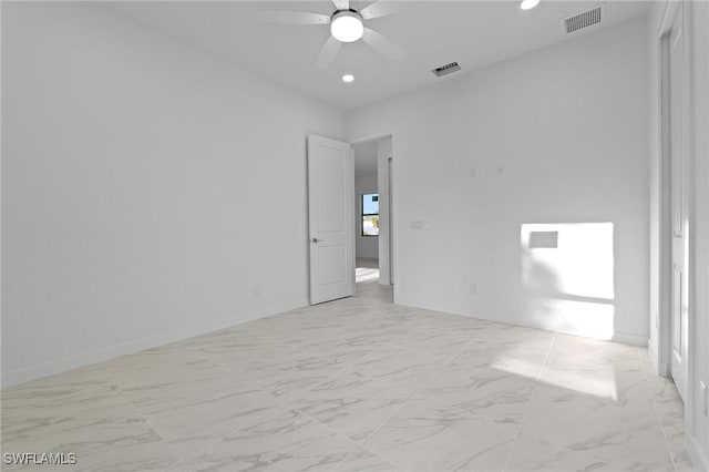 spare room with recessed lighting, a ceiling fan, visible vents, and marble finish floor