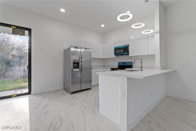 kitchen featuring a sink, stainless steel appliances, marble finish floor, and light countertops