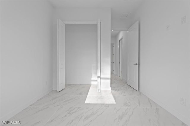 interior space with marble finish floor and baseboards