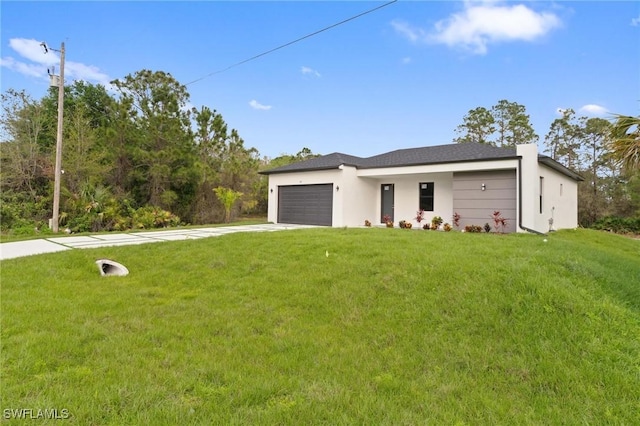 view of front of property with a garage, a front lawn, and driveway