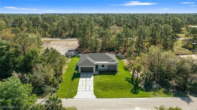 birds eye view of property featuring a wooded view