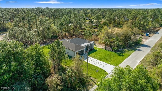 drone / aerial view featuring a forest view