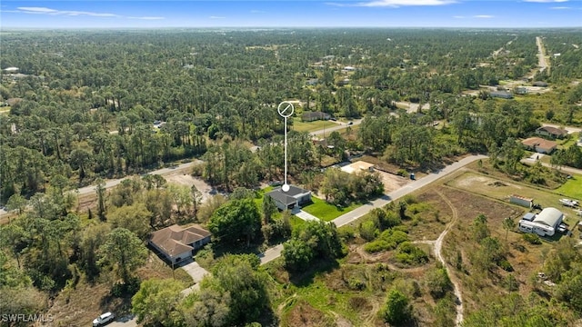 bird's eye view featuring a wooded view