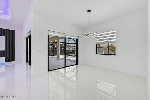 unfurnished room featuring a healthy amount of sunlight and marble finish floor