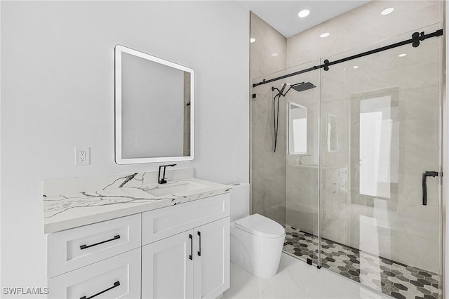 bathroom featuring marble finish floor, a stall shower, toilet, and vanity