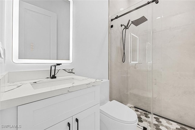 bathroom with vanity, toilet, and a stall shower