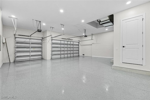 garage with a garage door opener and baseboards