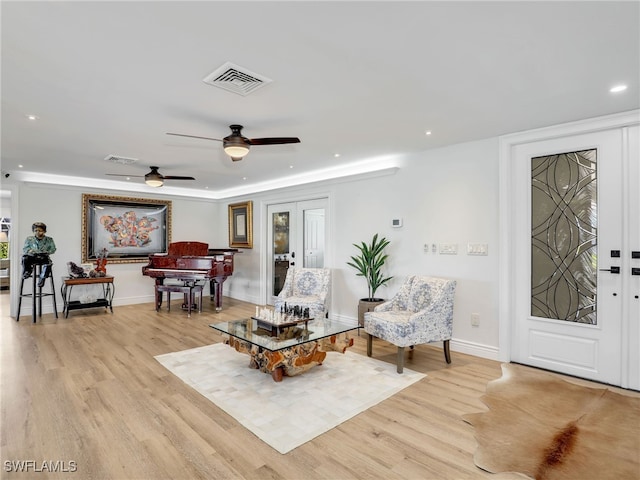 living area with recessed lighting, visible vents, baseboards, and light wood finished floors