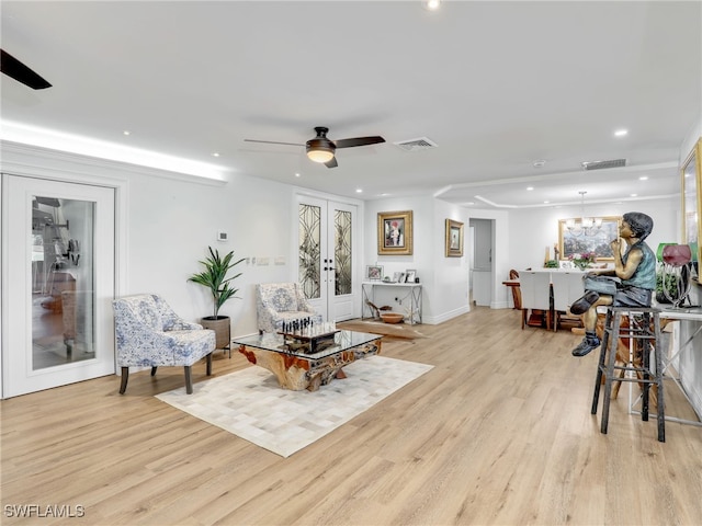 living area with light wood-type flooring, visible vents, ceiling fan, and recessed lighting