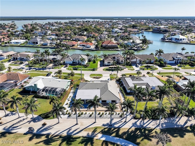 drone / aerial view featuring a residential view and a water view