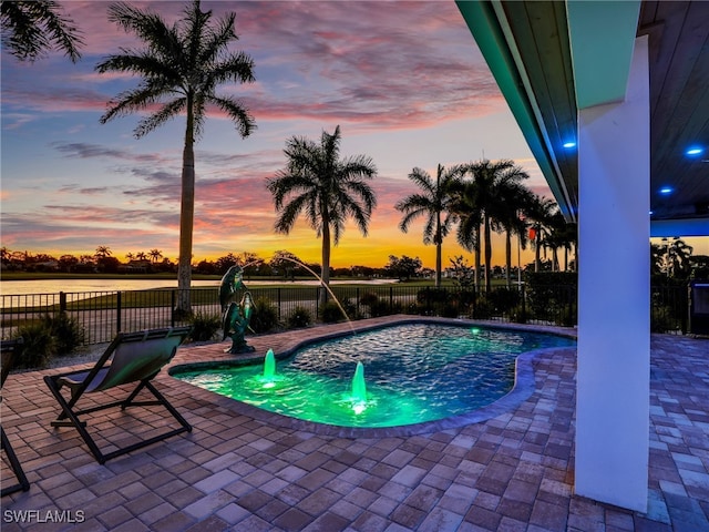 view of pool with a patio area and fence