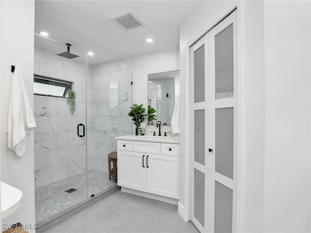 full bathroom with a marble finish shower, visible vents, recessed lighting, and vanity