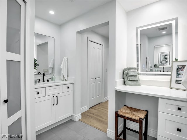 bathroom featuring vanity, visible vents, baseboards, recessed lighting, and tile patterned floors