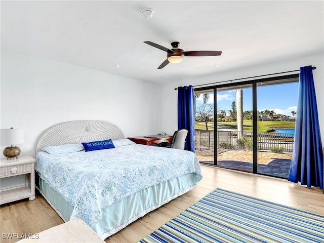 bedroom with access to exterior, light wood-style flooring, and a ceiling fan