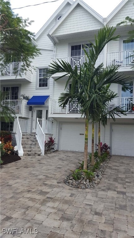 view of front of home featuring decorative driveway and an attached garage