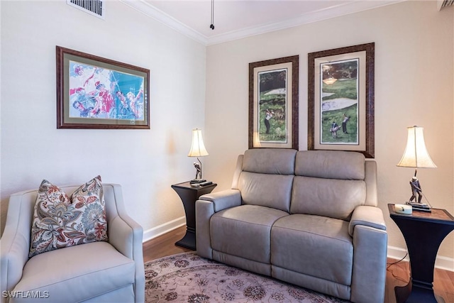 living room featuring baseboards, wood finished floors, visible vents, and ornamental molding