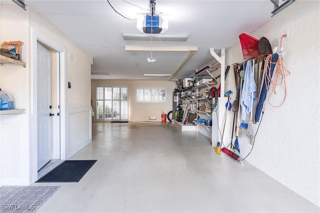 garage featuring gas water heater and a garage door opener