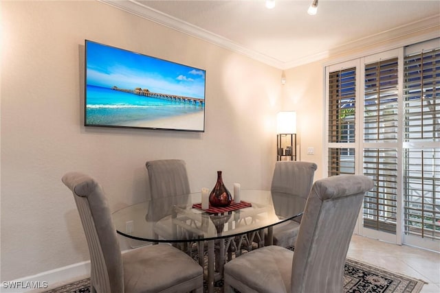 dining room featuring baseboards and ornamental molding