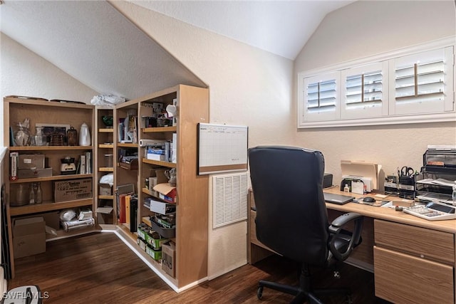 home office featuring dark wood finished floors, vaulted ceiling, and a textured wall