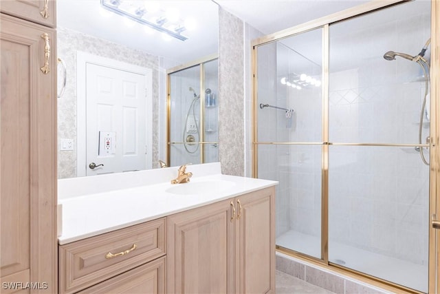 full bathroom with a stall shower and vanity