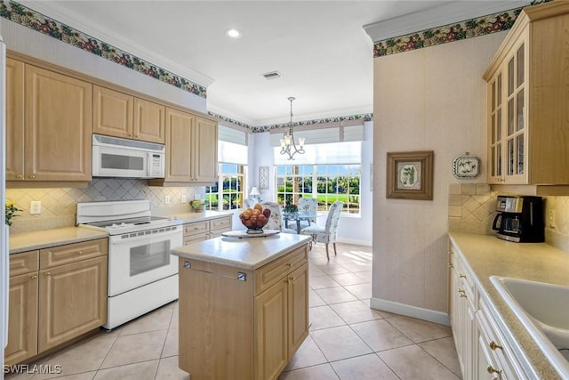 kitchen with white appliances, light countertops, visible vents, and light brown cabinetry