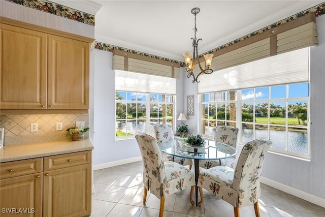 dining space featuring light tile patterned flooring, baseboards, and an inviting chandelier