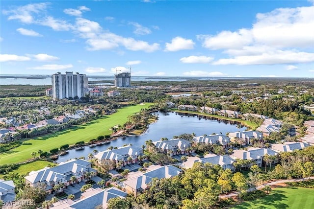 drone / aerial view featuring a residential view, view of golf course, and a water view