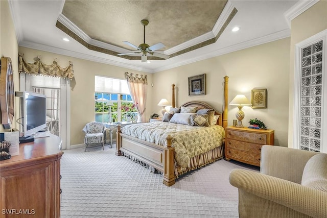 bedroom featuring baseboards, a raised ceiling, carpet floors, and ornamental molding