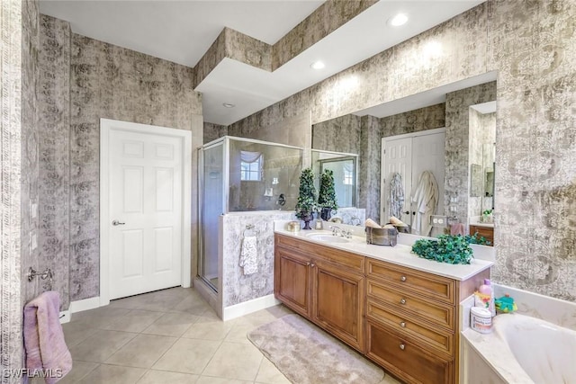 full bathroom featuring a stall shower, wallpapered walls, tile patterned flooring, a bath, and vanity