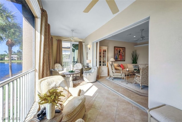 sunroom / solarium with a water view and a ceiling fan