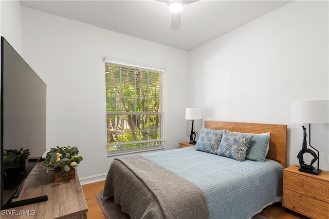 bedroom with a ceiling fan and wood finished floors