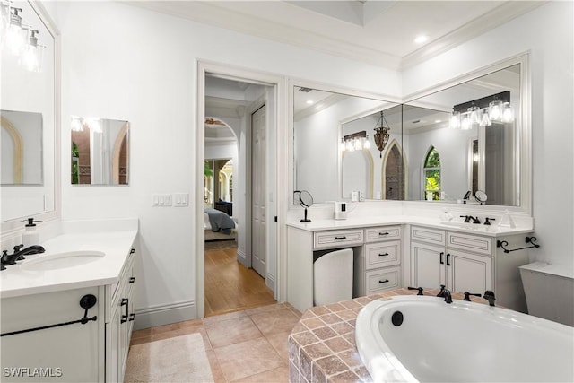 full bath with two vanities, ensuite bathroom, a sink, crown molding, and a bath