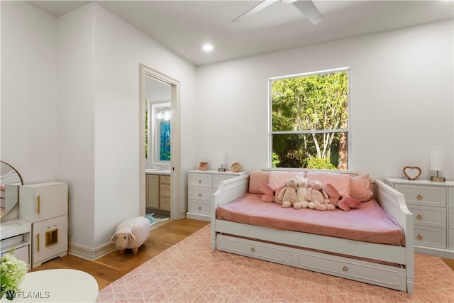 bedroom featuring light wood-style flooring, recessed lighting, connected bathroom, baseboards, and ceiling fan