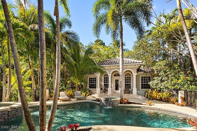 view of pool featuring a patio area, a fenced in pool, an in ground hot tub, and fence