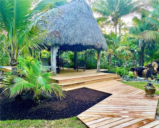 view of property's community with a gazebo and a wooden deck