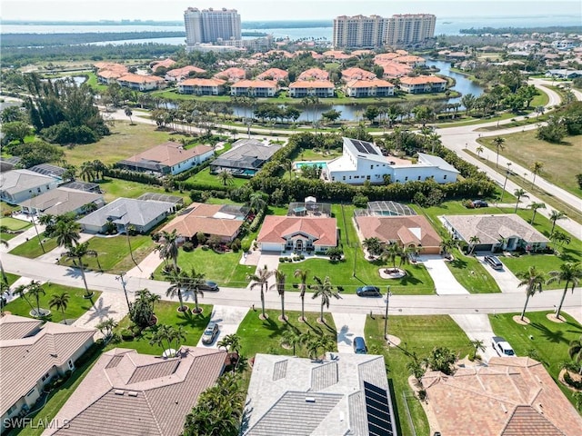 drone / aerial view featuring a residential view and a water view